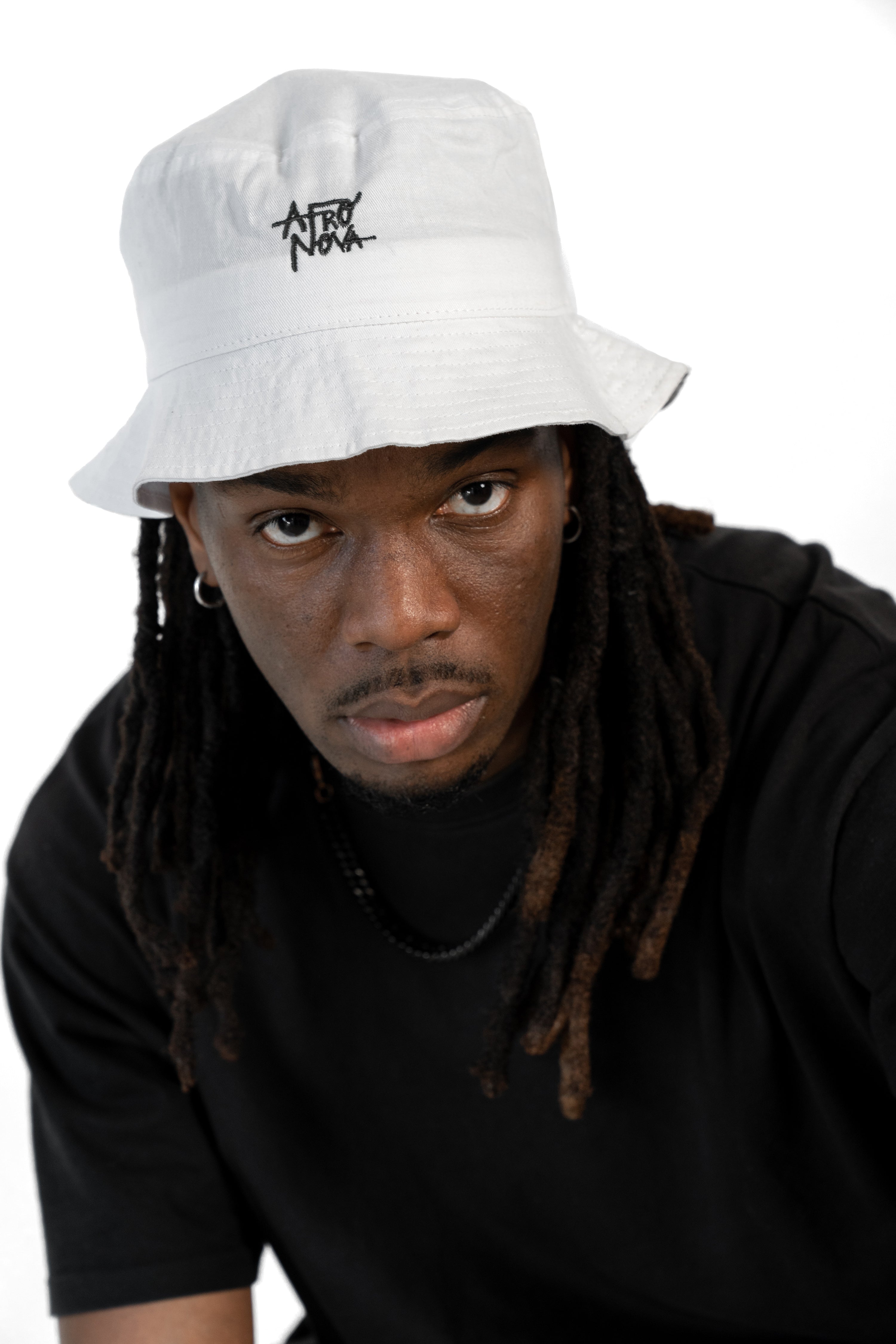 Black man with dreadlocks and white bucket hat